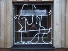 Geschmiedetes Fenstergitter für ein Kellerfenster mit Fabelwesen