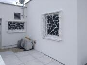 weiß lackierte Fenstergitter mit Schmitz Struktur