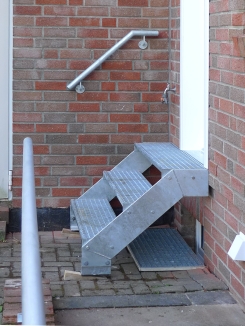 Treppe aus feuerverzinktem Stahl mit Gitterroststufen und einem Handlauf