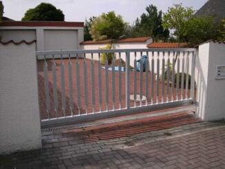 motorisierte Toranlage aus verzinktem Stahl mit torsierter Füllung und elektrischem Torantrieb