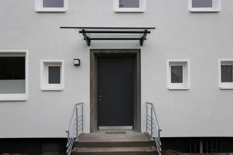 Vordach aus lackiertem Stahl und Glas