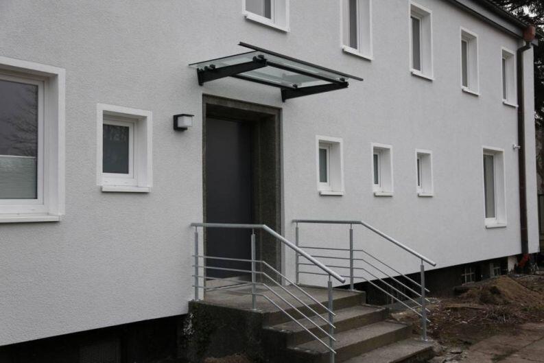 Vordach aus lackiertem Stahl und Glas