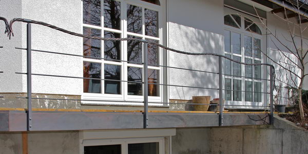 Dieses Terrassengeländer hat als Handlauf ein Seil aus Kupfer